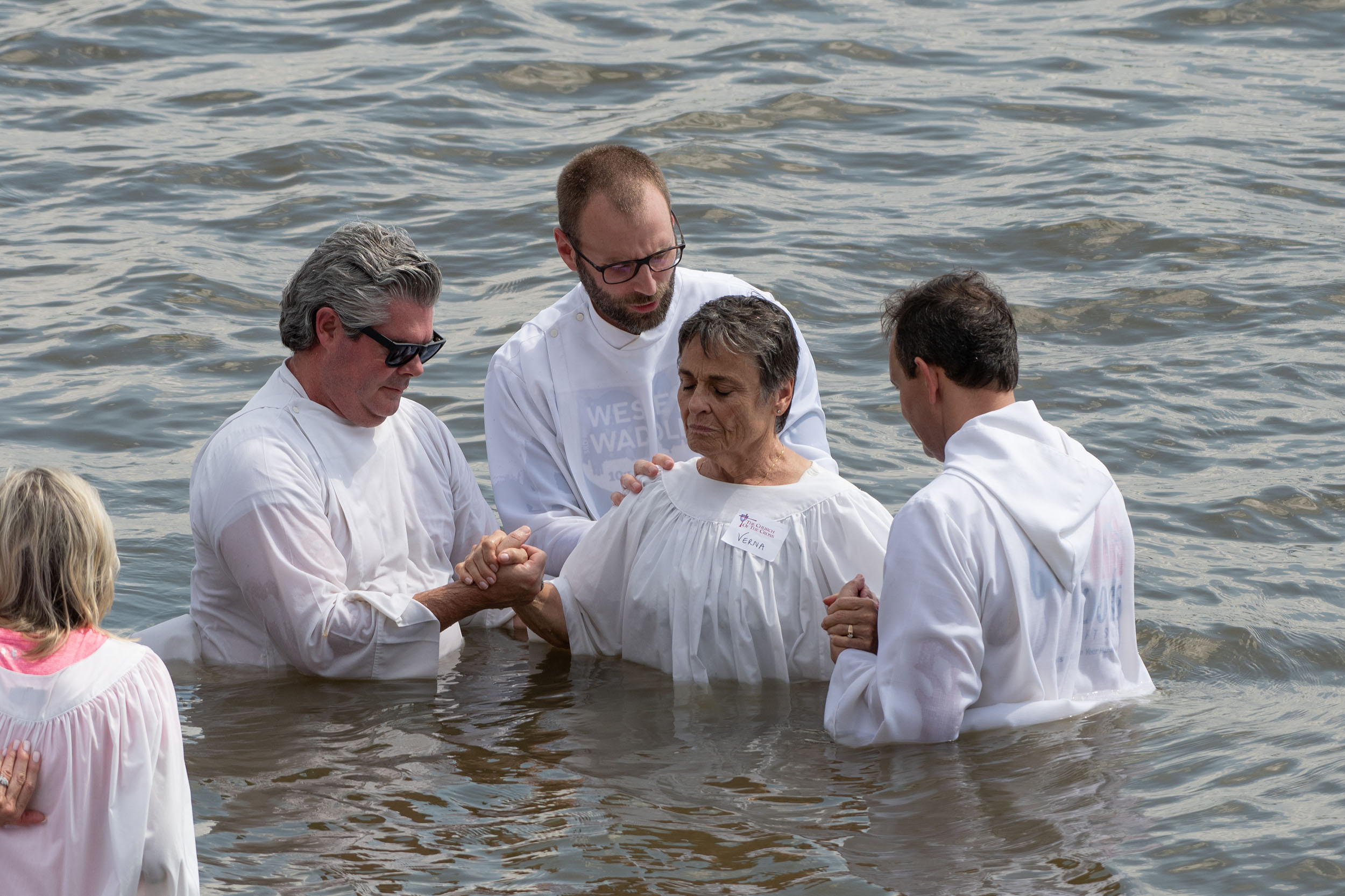 A river baptism being performed at The Church of the Cross